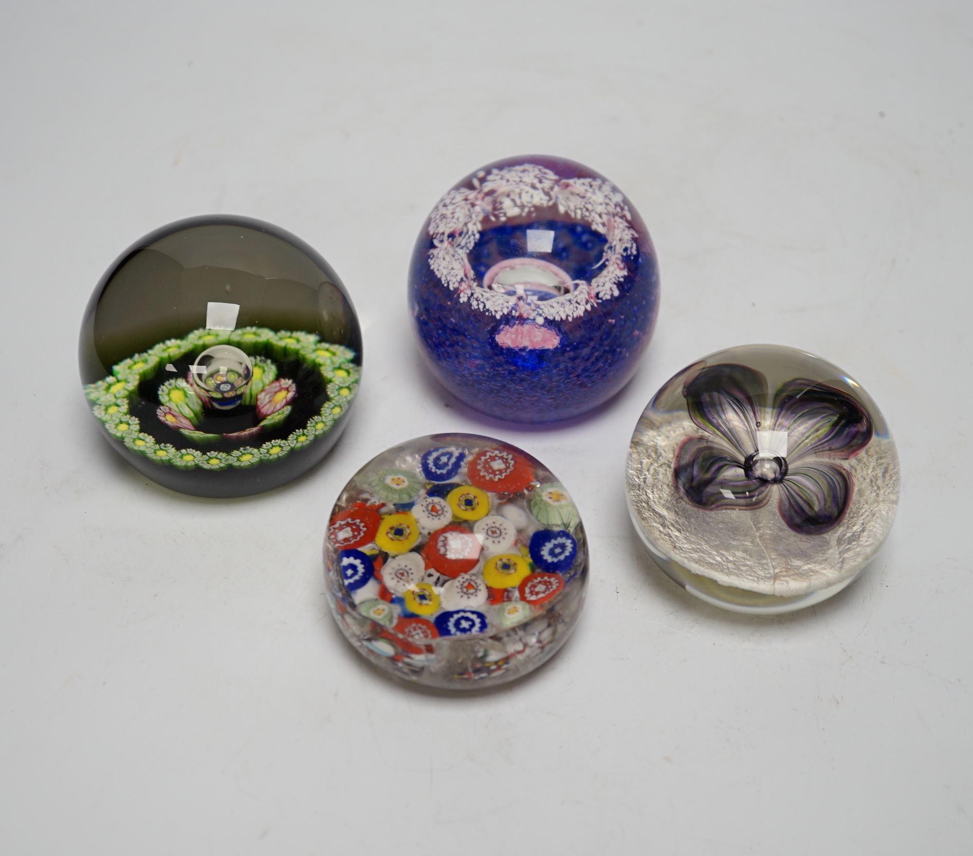 A collection of nineteen glass paperweights; mostly Caithness with two being Whitefriars and another Perthshire